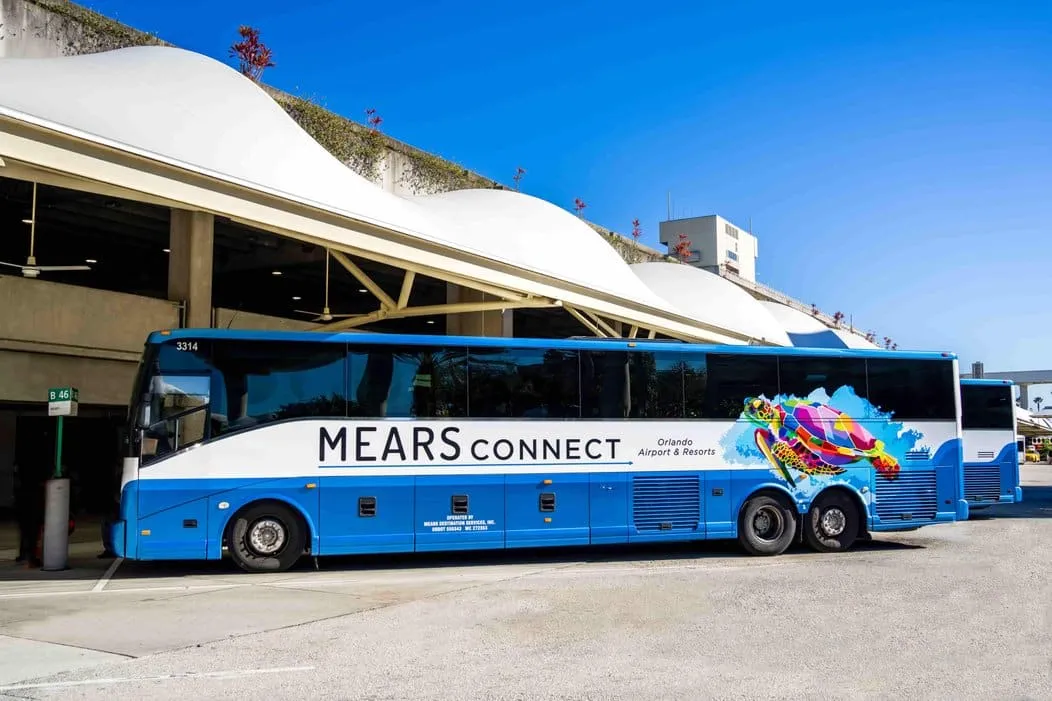 Motorcoach loading outside Orlando International Airport for the drive to Disney World