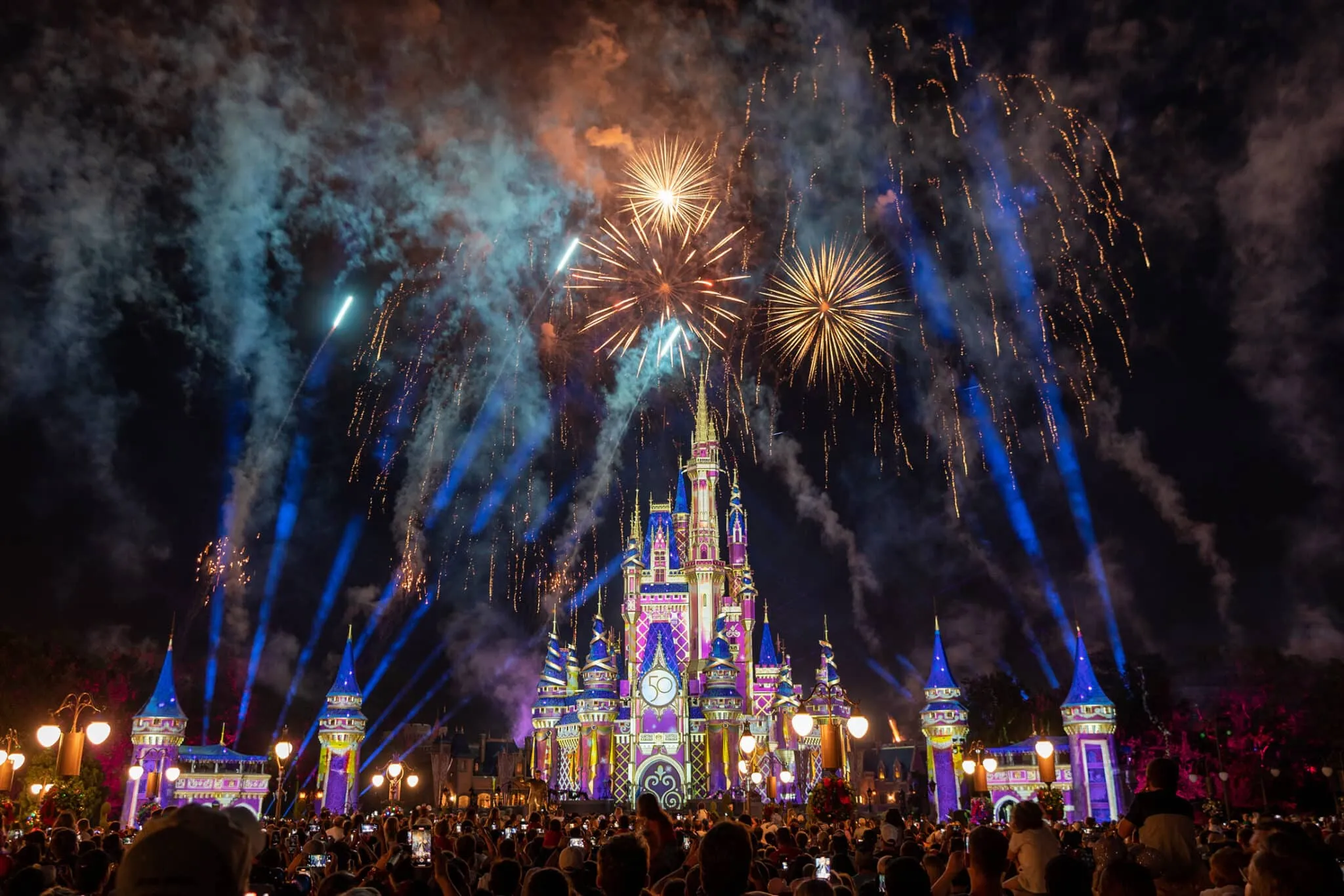 a castle with fireworks in the sky
